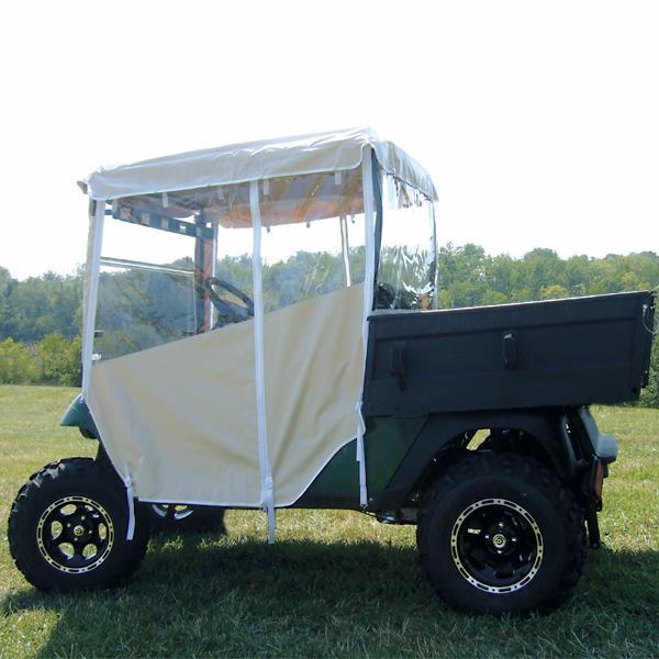 Tan three-sided enclosure fitted to a utility golf cart, with transparent side panels.